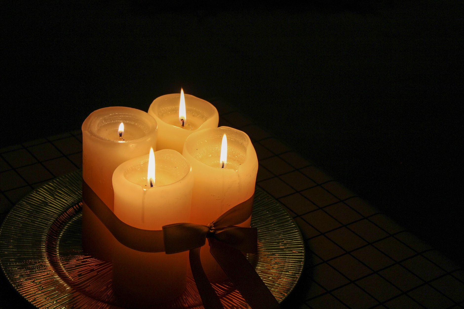 Cozy setup with four lit candles, perfect for creating a warm ambiance.