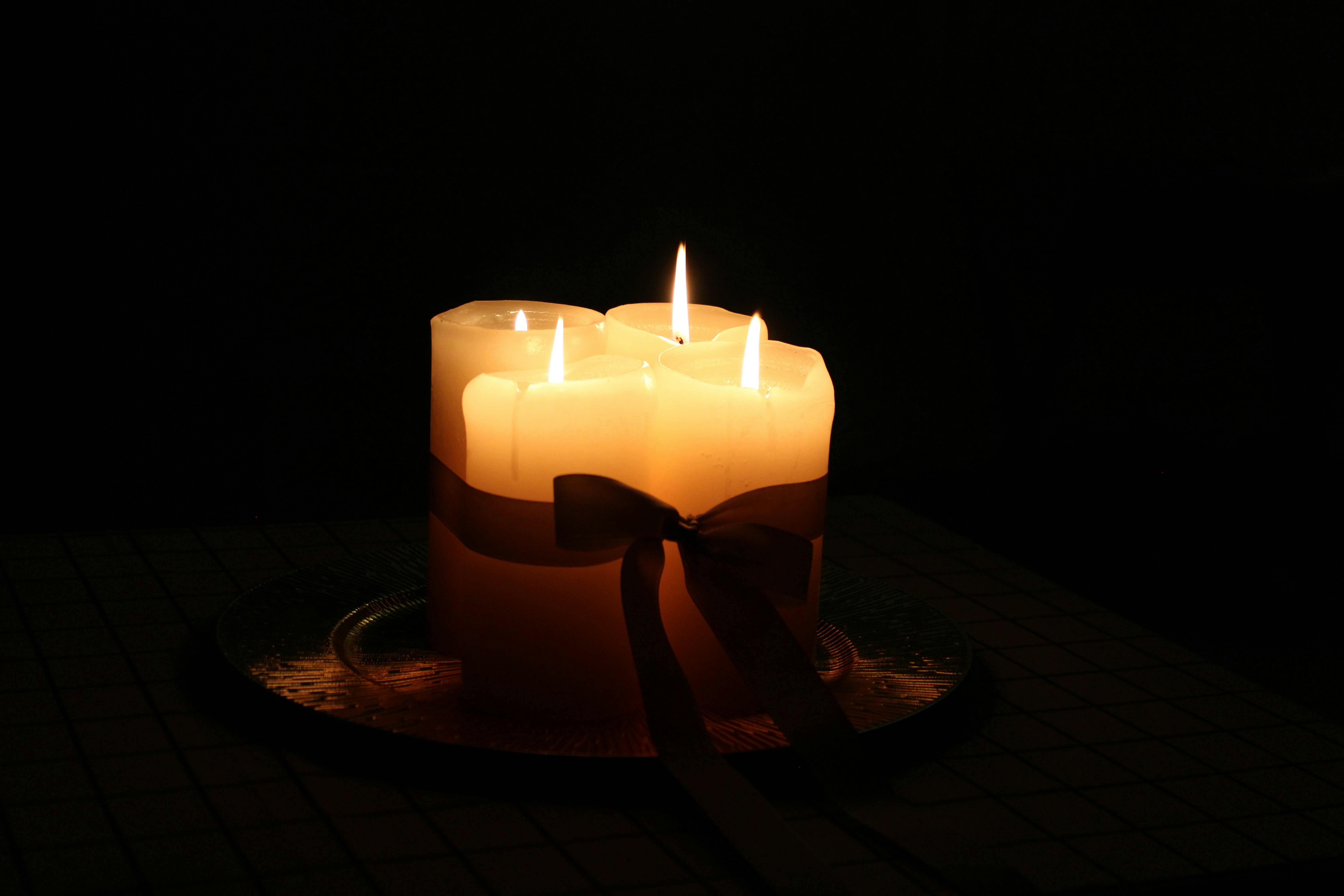 Warm candlelight illuminating a dark room, creating an ambient and serene atmosphere.