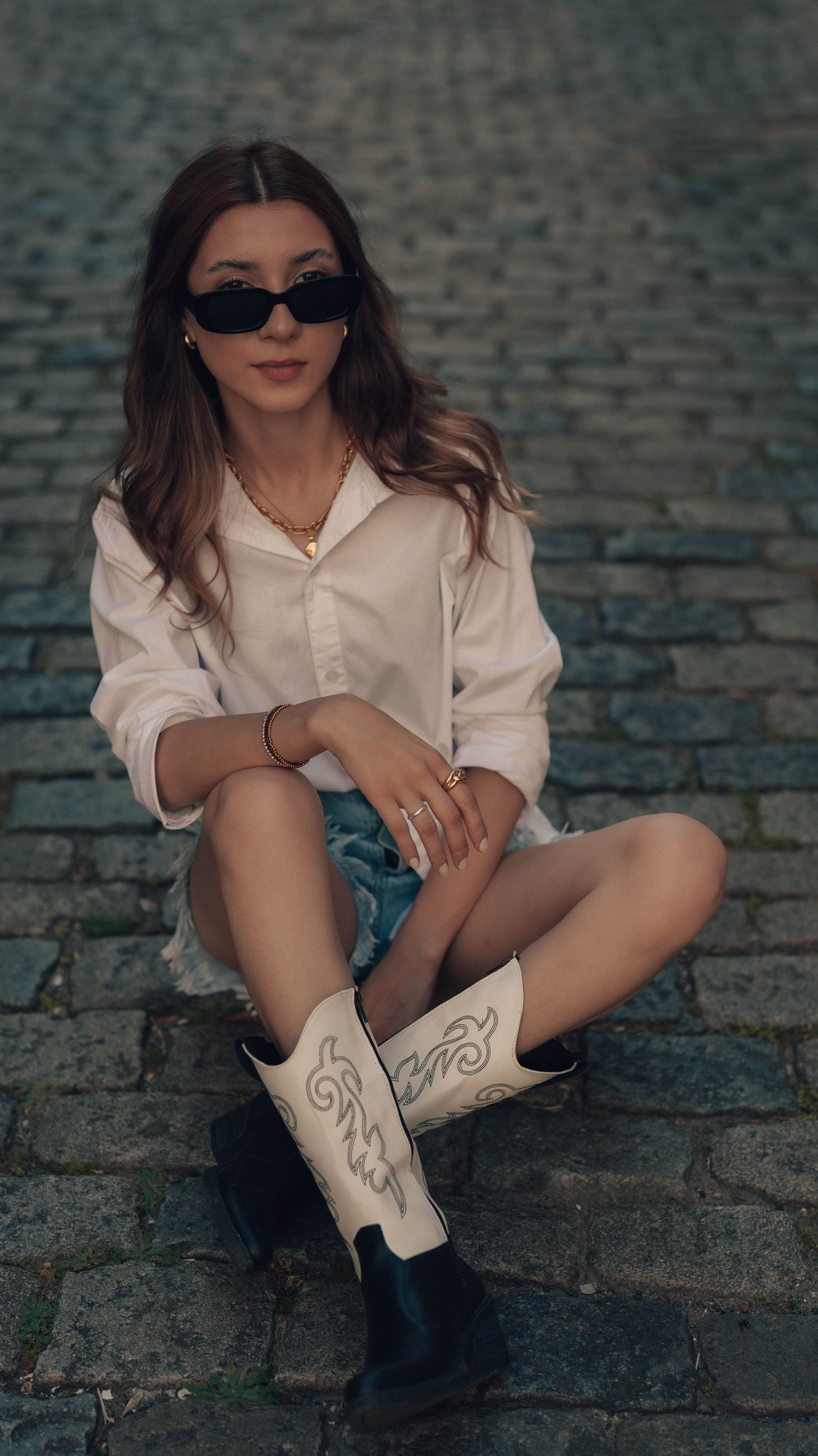 Stylish Woman in Sunglasses and Cowboy Boots on Cobblestone · Free ...