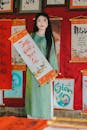 Woman Holding Traditional Scroll in Cultural Setting