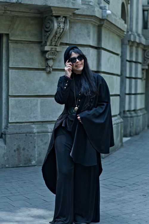 Free A fashionable woman in black attire, posing confidently on a historic street in Mexico City. Stock Photo