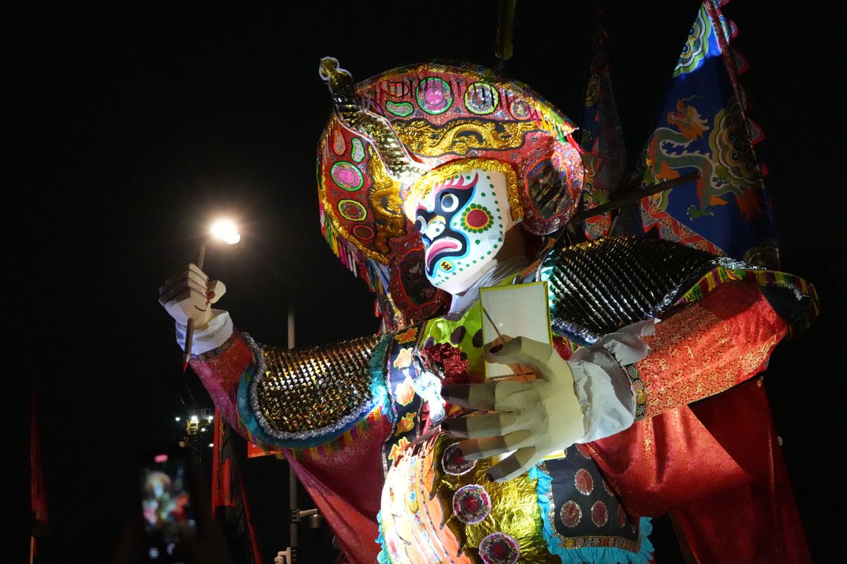 Vibrant festival costume performer photographed at night in Hong Kong