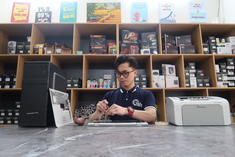 Technician repairing a computer in the shop