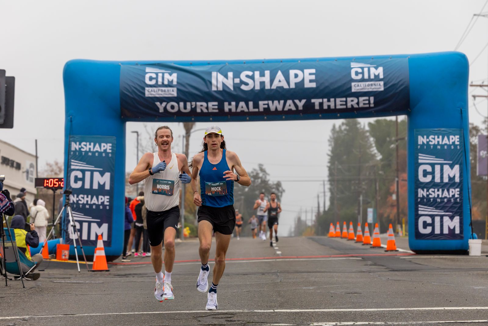 Marathon runners at the halfway arch