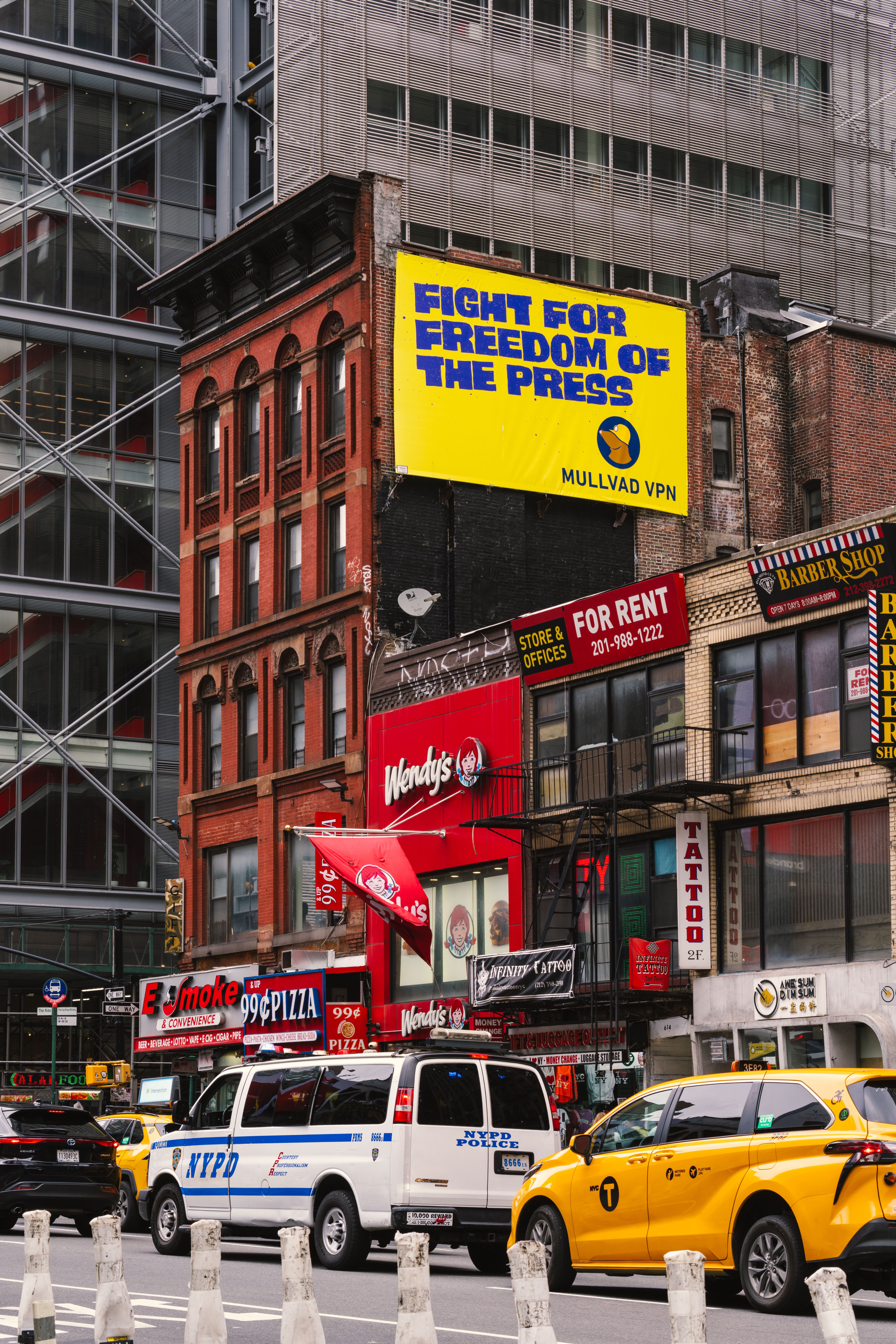 Lively street view of New York City with taxis, buildings, and eye-catching billboards.