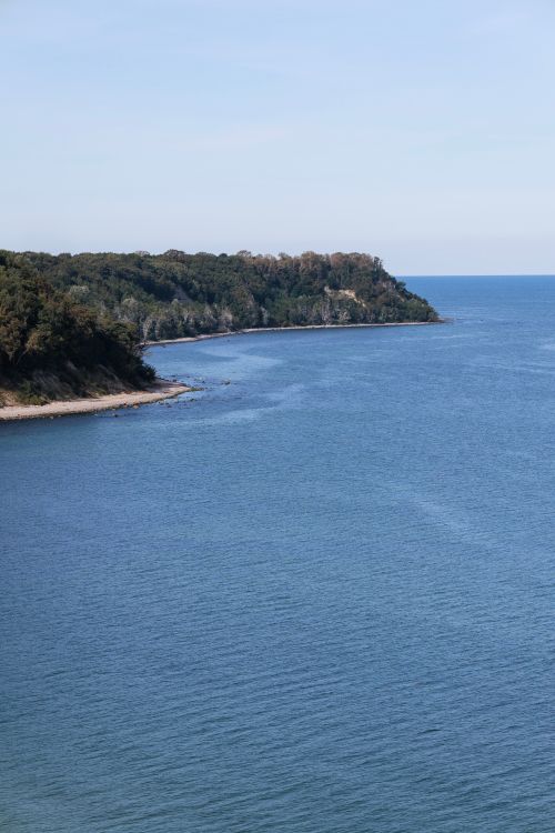 Free Stunning coastal landscape capturing calm waters and lush cliffs, perfect for nature enthusiasts. Stock Photo