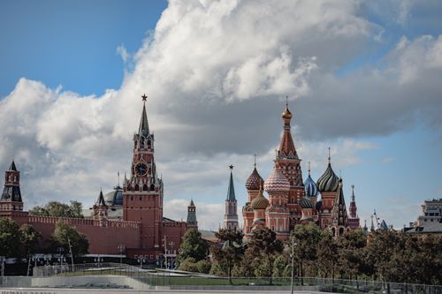 Free Stunning view of the Kremlin and Saint Basil's Cathedral in Moscow, Russia under a partly cloudy sky. Stock Photo