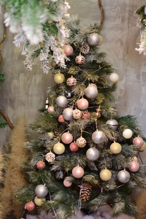 Free Elegant Christmas tree with shimmering ornaments indoors, creating a festive atmosphere. Stock Photo