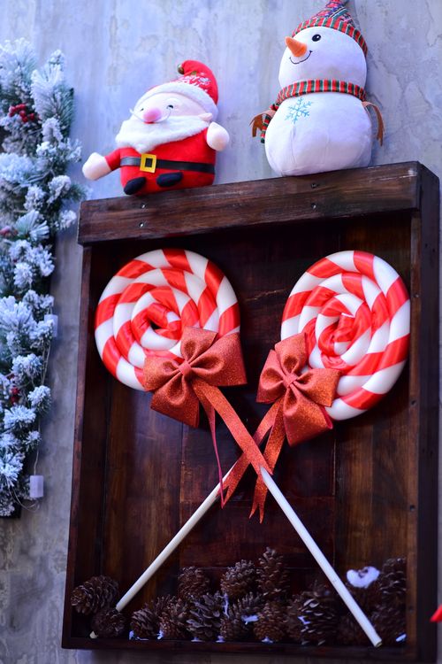 Free Christmas-themed setup with plush toys, candy canes, and pinecones. Stock Photo