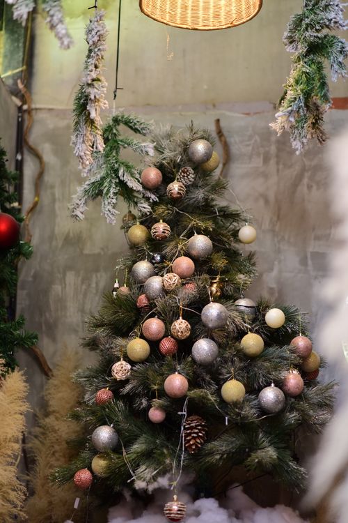 Free Beautifully decorated Christmas tree with ornaments and pinecones indoors. Stock Photo