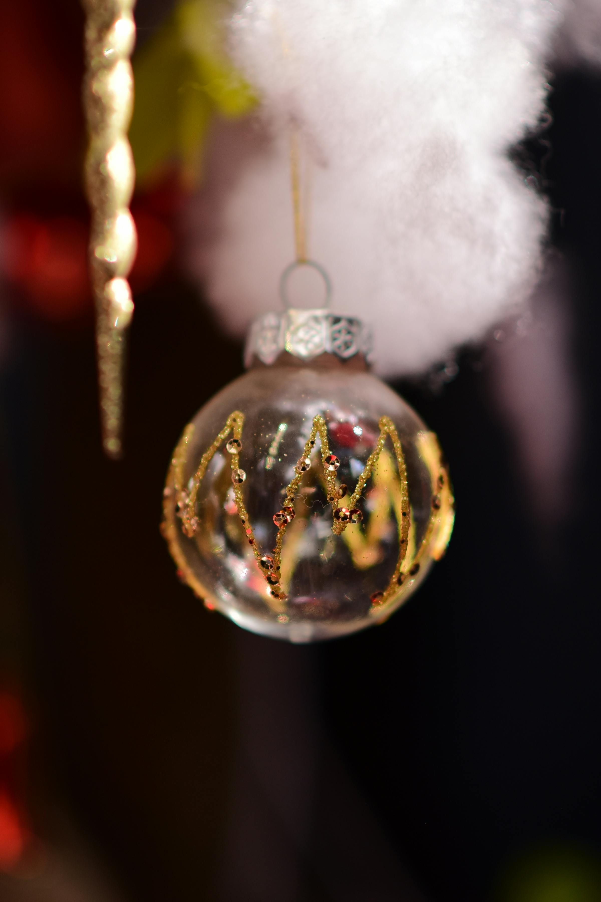 Festive Christmas ornament hanging on a decorated tree branch.