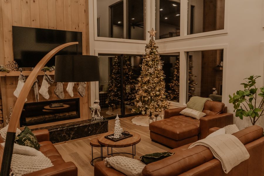 Living room decorated for Christmas with a tree and fireplace