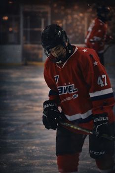 Hockey player in action on ice rink during an intense game moment.