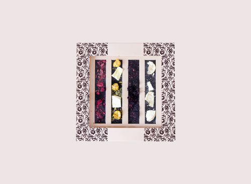 Free A beautiful assortment of gourmet chocolate bars in decorative packaging, featuring various flavors and textures. Stock Photo