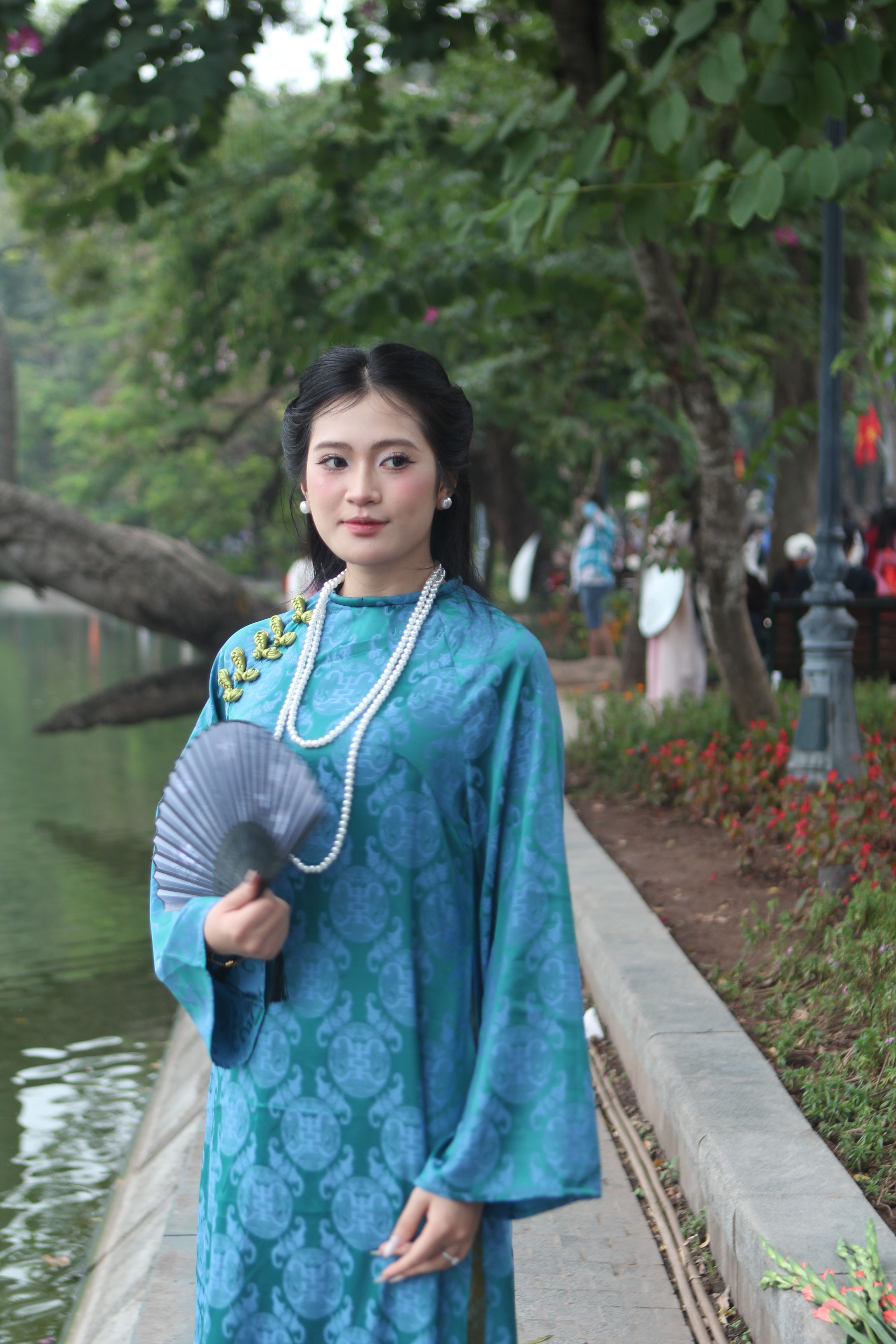 Elegant Woman in Traditional Blue Dress by Lake · Free Stock Photo