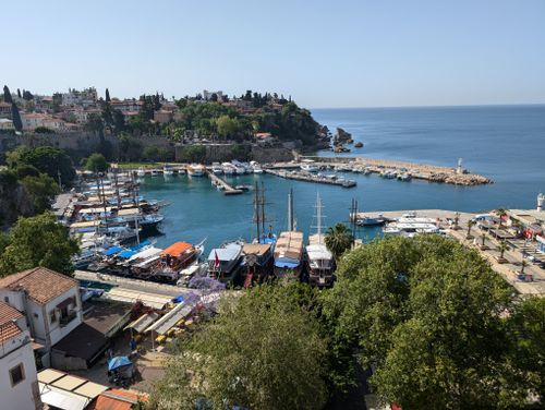 Free Beautiful view of Antalya harbor with boats and historic old town in Türkiye. Stock Photo