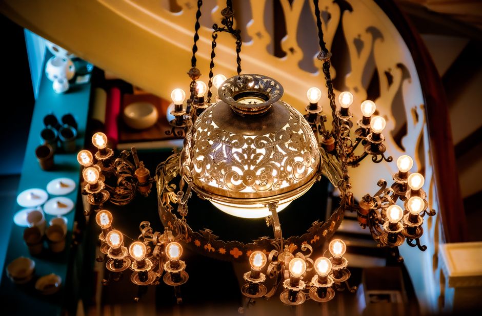 Stunning vintage chandelier illuminating an elegant interior setting with warm lights.