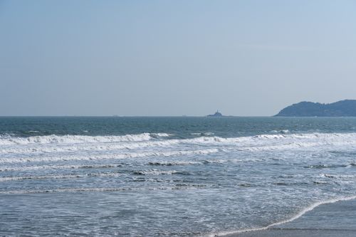 Free Peaceful ocean scene featuring gentle waves under a clear blue sky, ideal for relaxation concepts. Stock Photo