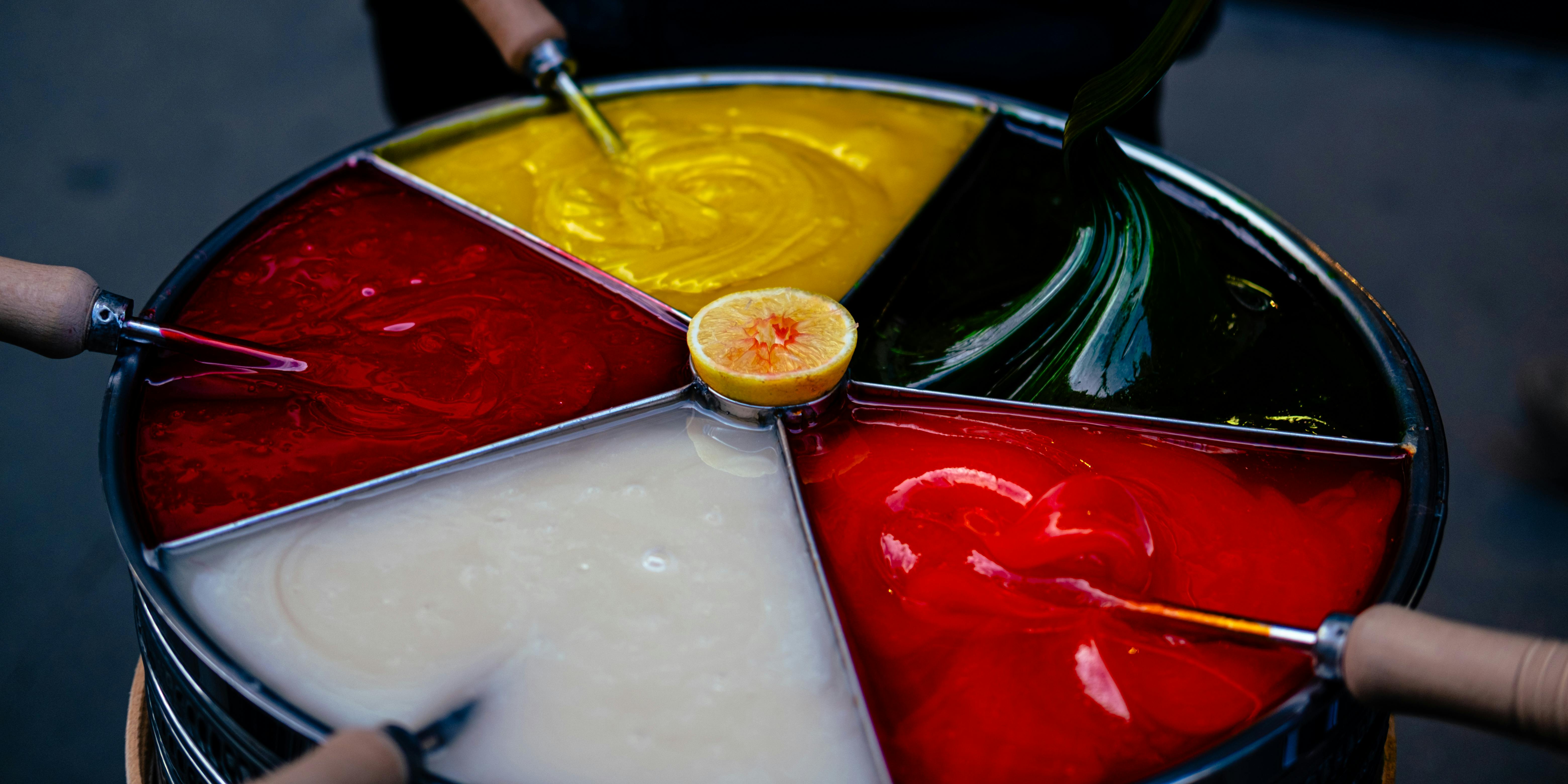 Close-up of vibrant Turkish macun candy in five colors with lemon center.
