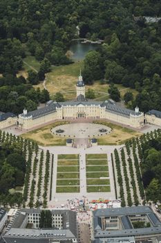 Stunning aerial shot of Karlsruhe Palace, showcasing symmetrical gardens and green surroundings.