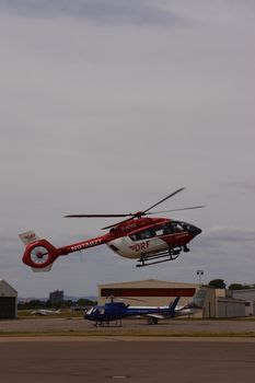 Air rescue helicopter in flight at Mannheim Airport, showcasing emergency response capabilities.
