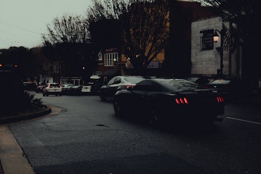 Dramatic rainy evening in downtown Georgia with wet streets and cars.