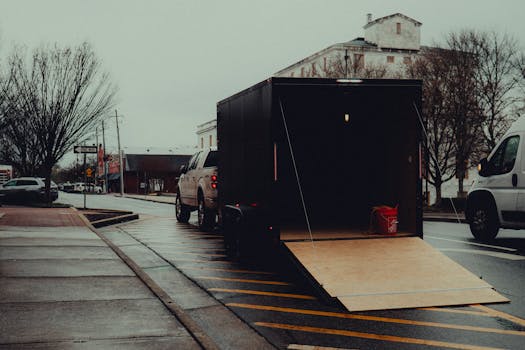 Dramatic rainy street scene in downtown Canton, Georgia with an open trailer.