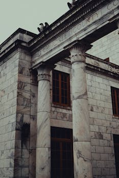 Moody view of the historic Cherokee County Courthouse with dramatic rain-soaked atmosphere.