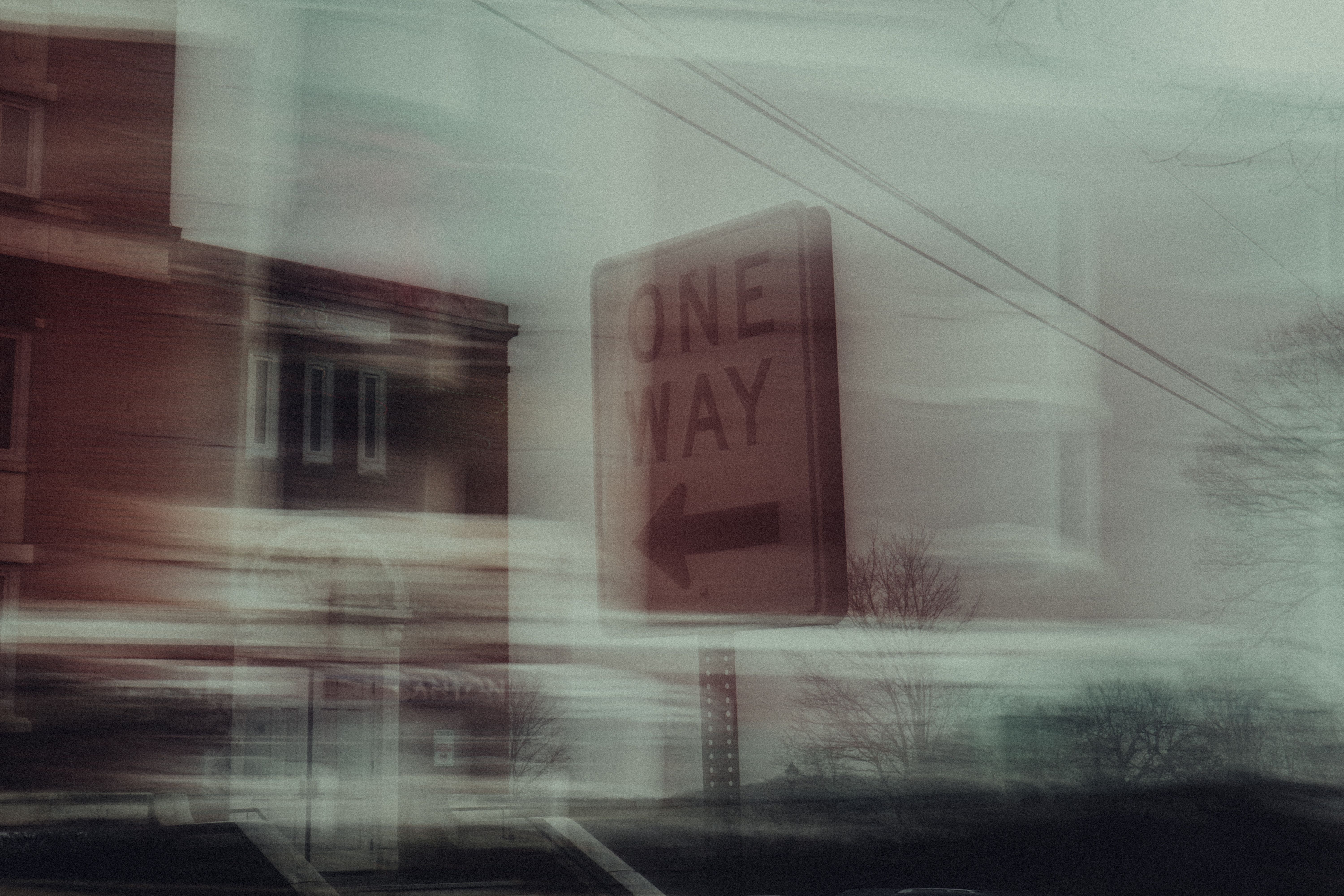 Abstract cityscape with a blurred one-way sign capturing urban motion.