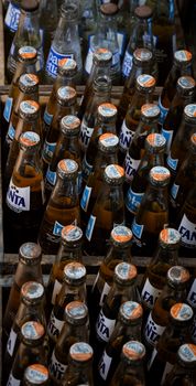 Retro glass Fanta bottles arranged in a rustic wooden crate, perfect for vintage and nostalgic themes. - Fotografer Sidoarjo