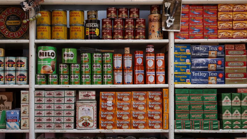A nostalgic view of vintage grocery store shelves filled with assorted food products and drinks.