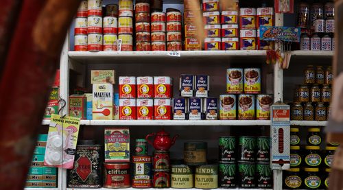 Free Explore classic canned goods on vintage grocery store shelves, showcasing nostalgic packaging and colors. Stock Photo