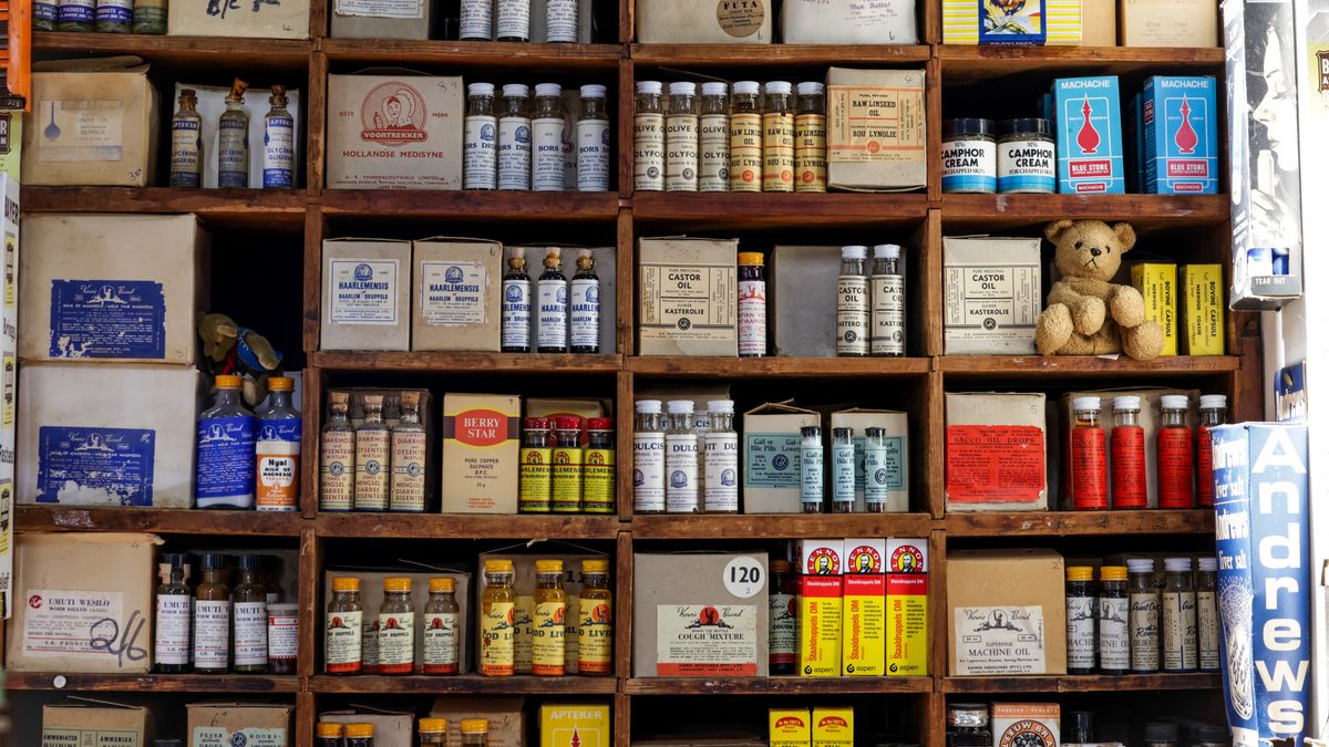 A vintage pharmacy shelf filled with old medicine bottles and boxes, showcasing a nostalgic aesthetic.