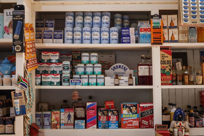 A vintage shop shelf featuring retro packaging of various products and medicinal items.