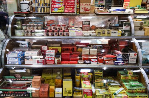 Free A nostalgic view of vintage pharmacy products displayed in a retro shop setting. Stock Photo