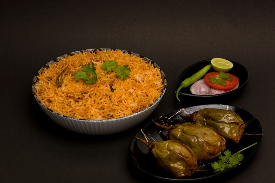 Delicious Indian biryani with stuffed peppers, garnished with fresh herbs, creating a vibrant and appetizing meal.