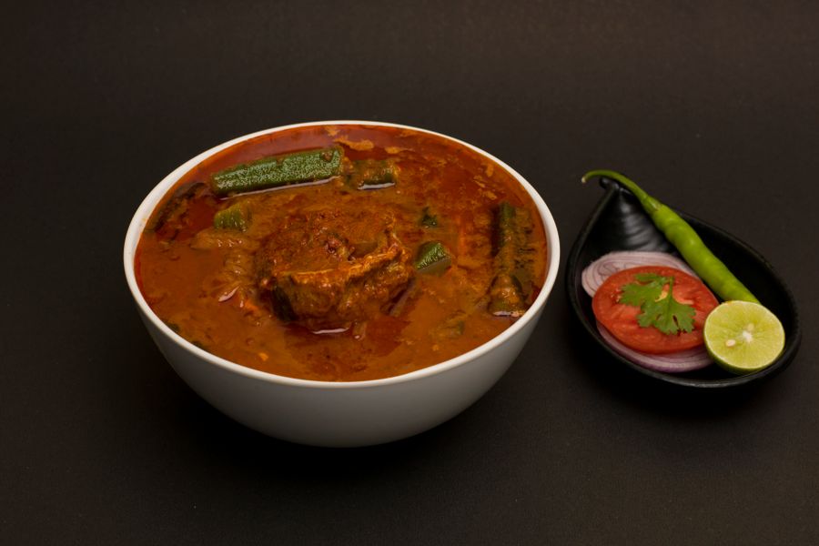 Delicious spicy mutton curry with vegetables, garnished with spices. Perfect for Indian cuisine lovers.