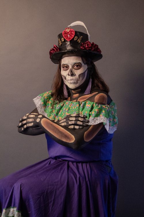 Free A woman in a colorful skeleton costume posing for Dia de los Muertos. Stock Photo