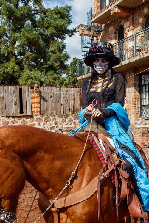 Free A woman in Day of the Dead makeup rides a horse in Ciudad de México. Stock Photo