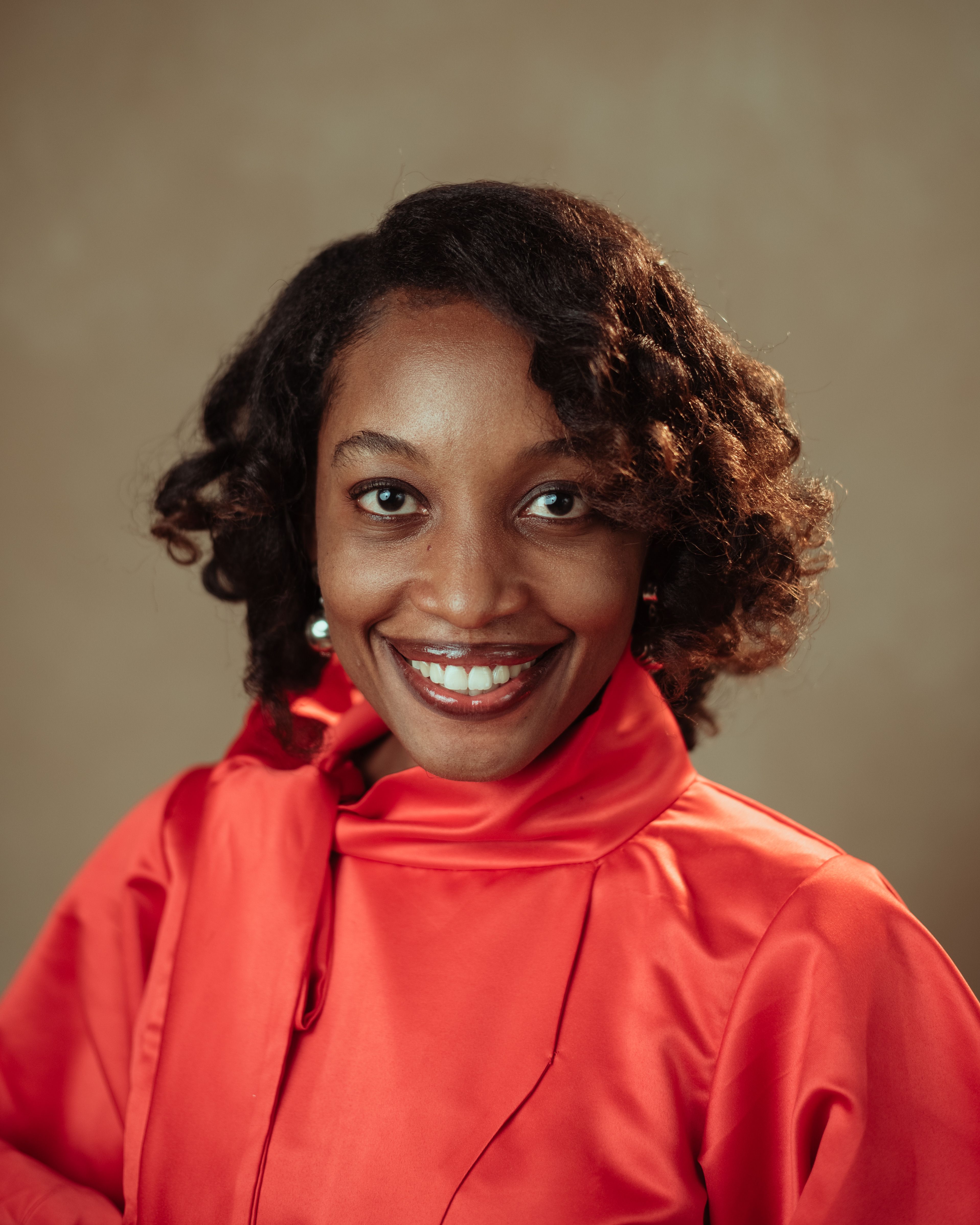 Portrait of a Smiling Woman in Red Attire · Free Stock Photo