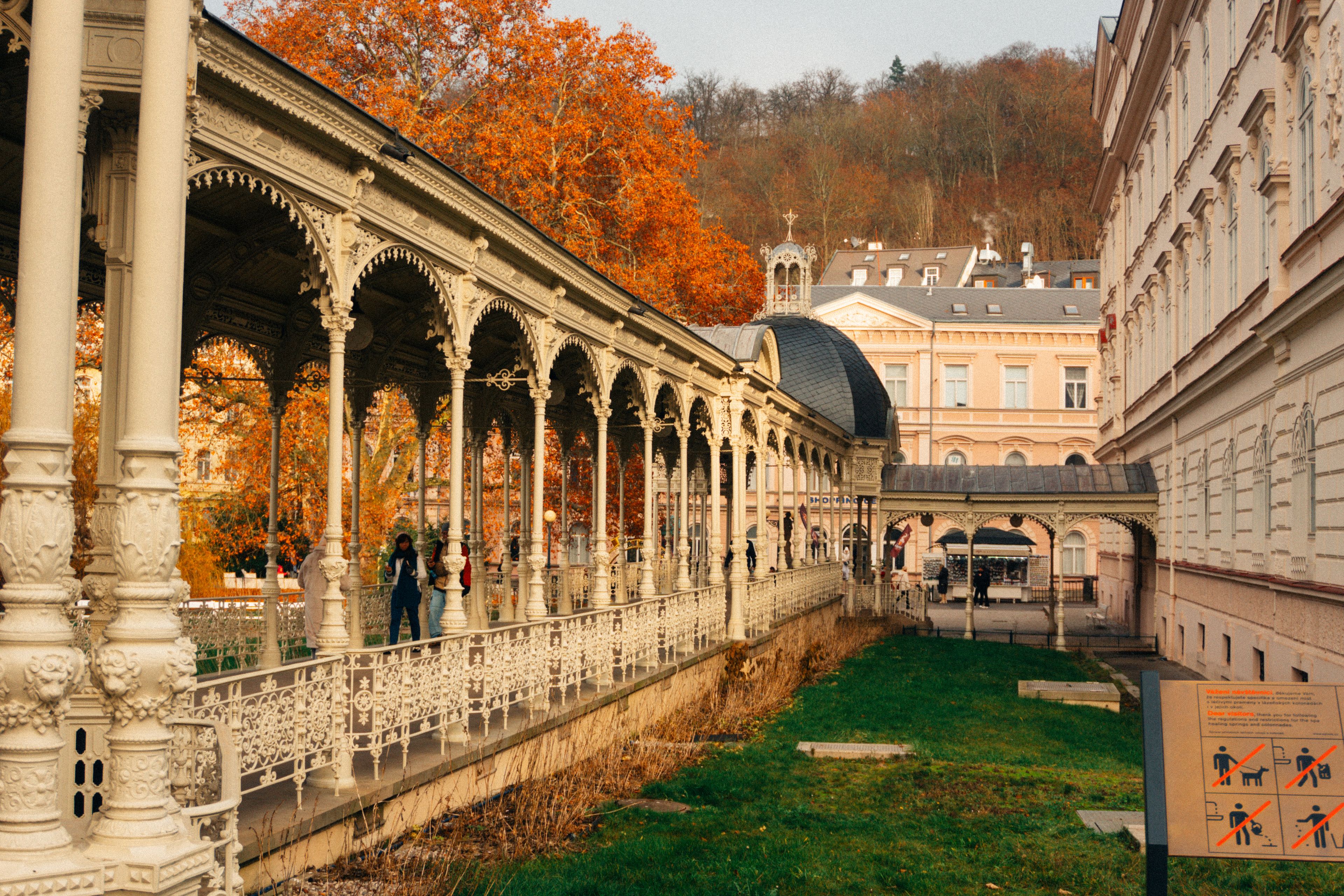 Elegant colonnade in Karlovy Vary, Czech Republic with vibrant autumn colors enhancing the architectural beauty.