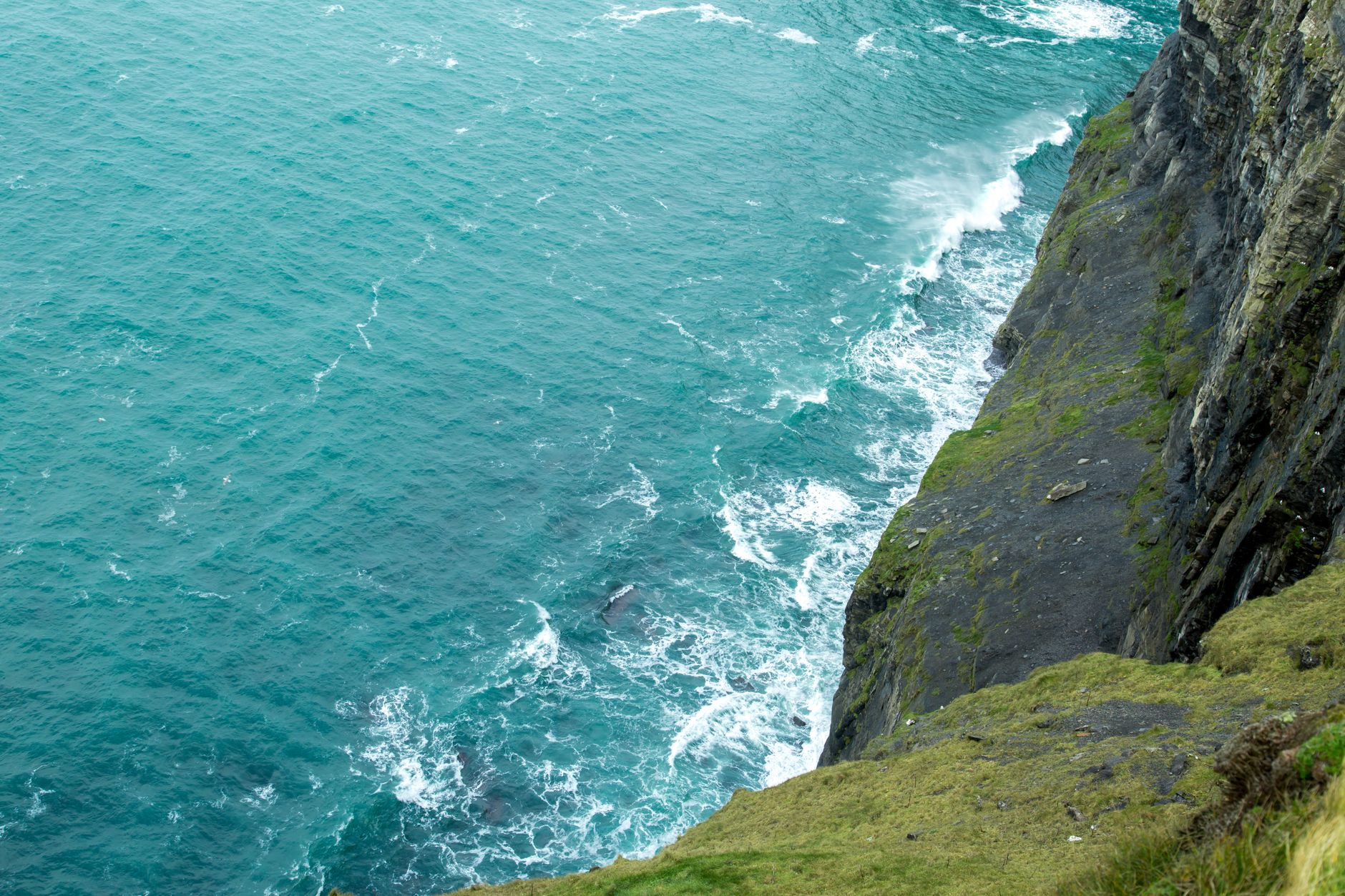 Stunning view of Irish cliffs and ocean waves crashing at the base. — photo by Michael Fischer / Pexels