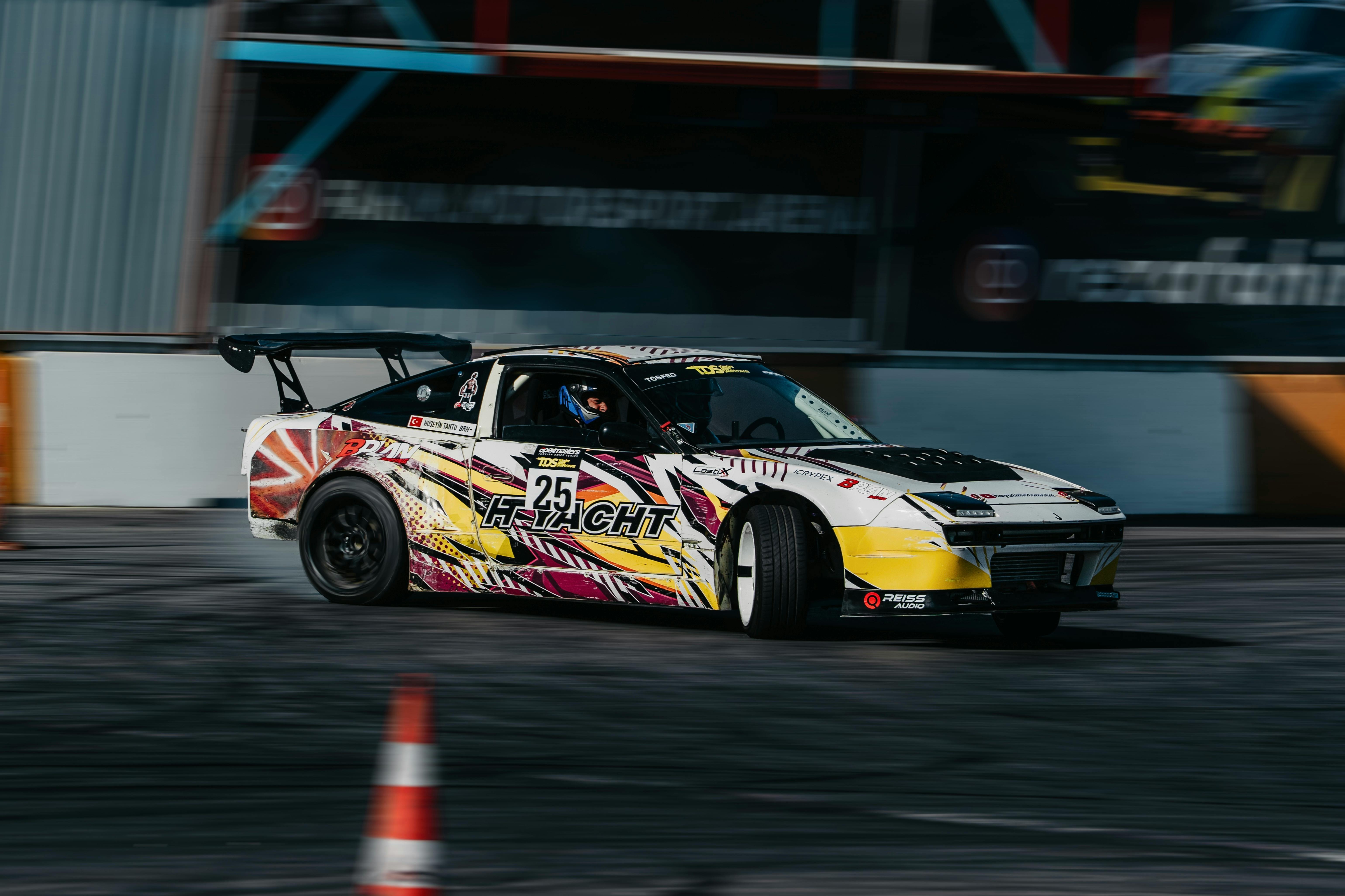 Dynamic shot of a racing car drifting on a track during daylight in Istanbul, Turkey.