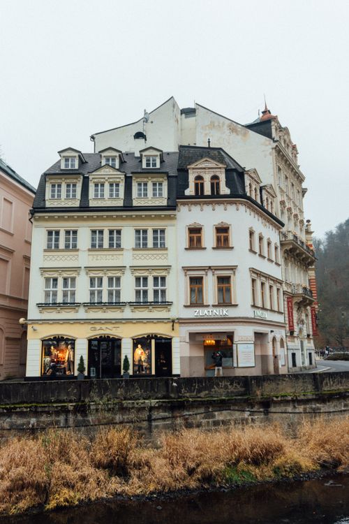 Free Charming historic European building by a tranquil riverside in autumn. Stock Photo