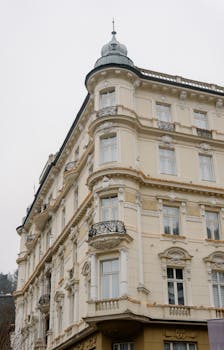 Discover this elegant European neoclassical building with ornate details and a vintage appeal.