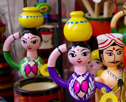 Vibrant hand-painted wooden figurines reflecting traditional Indian culture.