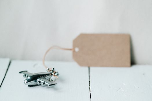 A toy airplane with a blank tag, ideal for travel concept or gift ideas.
