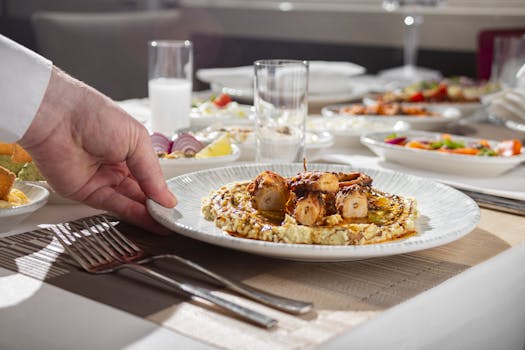 Close-up of a gourmet octopus dish being served at an elegant dining table.