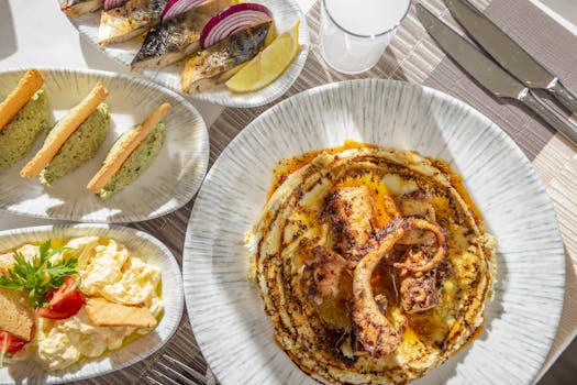 Delicious fine dining seafood platter featuring grilled octopus and fresh sides served on elegant tableware.