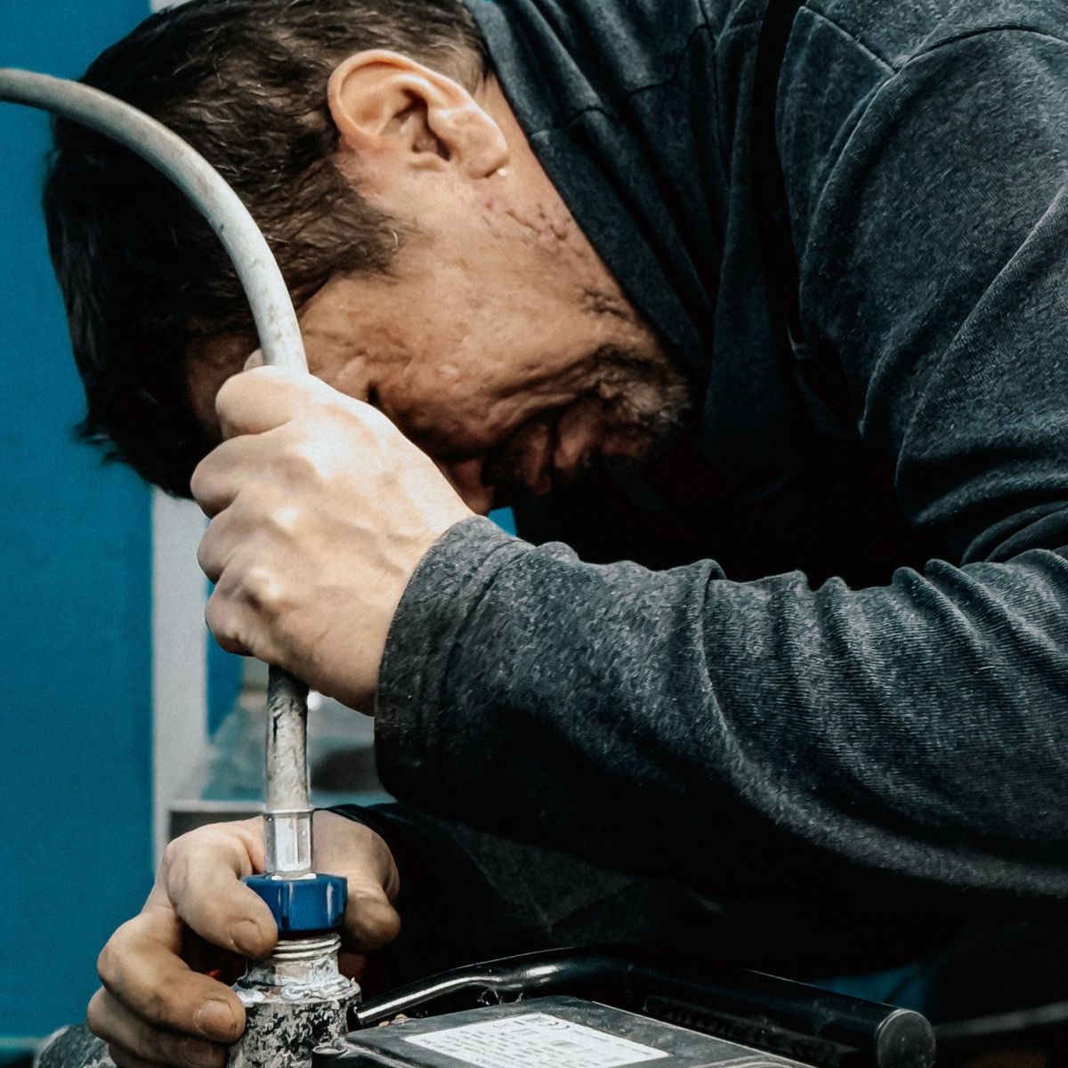 A technician working on a water pump